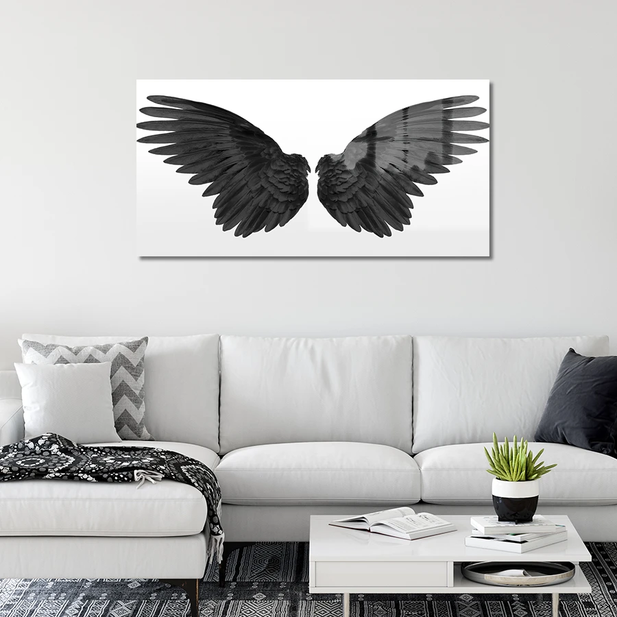 154054638-black-wings-on-white-background-lifestyle a pair of black wings on a white background, printed on a glass wall art, hanging on a wall.