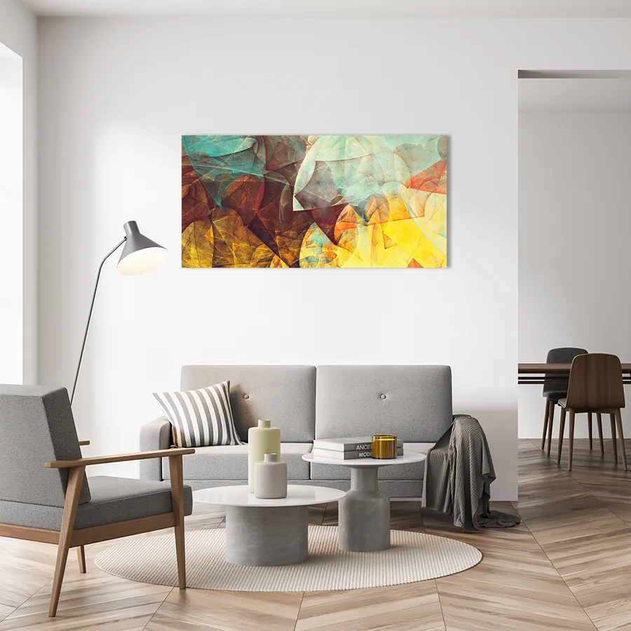 3022854302-autumn-leaves-lifstyle copy glass wall art of an abstract, colourful geometric design, in orange and yellow, hanging above a modern sofa