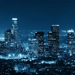 aerial view of LA skyline at night, in blue tones, printed as a glass wall art piece